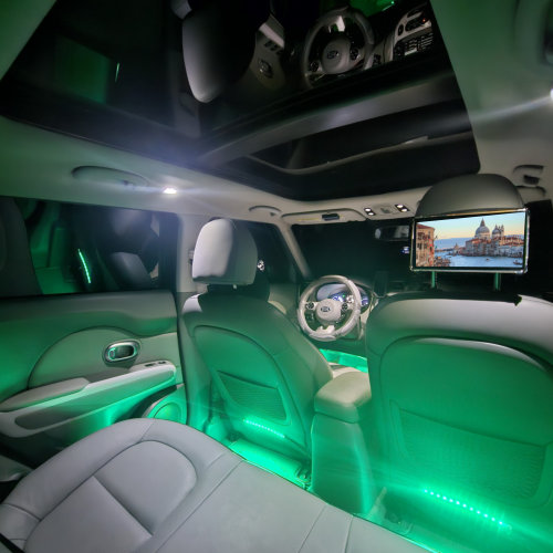 The backseat interior of the fully loaded KIA Soul EV+ with leather interior, panoramic moonroof, custom interior lighting, and premium sound system.